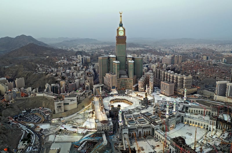 This picture taken on May 24, 2020 during the early hours of Eid al-Fitr, the Muslim holiday which starts at the conclusion of the holy fasting month of Ramadan, shows an aerial view of Saudi Arabia's holy city of Mecca, with the Abraj al-Bait Mecca Royal Clock Tower overlooking the Grand Mosque and Kaaba in the centre. - Saudi Arabia began a five-day, round-the-clock curfew from May 23 after COVID-19 coronavirus infections more than quadrupled since the start of Ramadan to around 68,000 -- the highest in the Gulf. (Photo by STR / AFP)