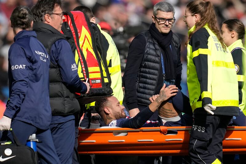 PSG's Neymar is carried off the field on a stretcher after an injury. AP