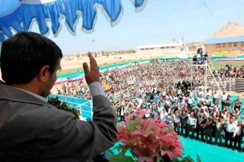 A handout picture released by Mahmoud Ahmadinejad's official website shows the Iranian president waving at supporters during a visit to Abu Musa.