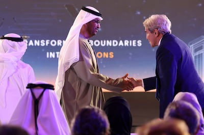 Dr Sultan Al Jaber, President-designate of Cop28 and Minister of Industry and Advanced Technology, welcomes US climate envoy John Kerry at the Atlantic Council Global Energy Forum in Abu Dhabi. AFP