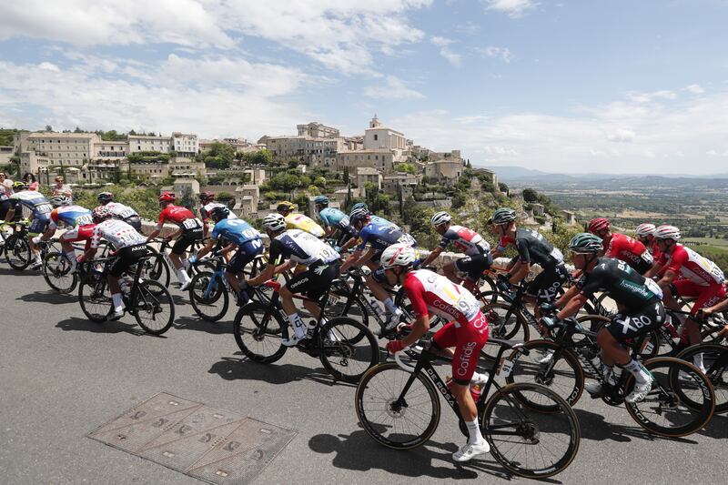 The peloton pass the town of Gordes during Stage 11.