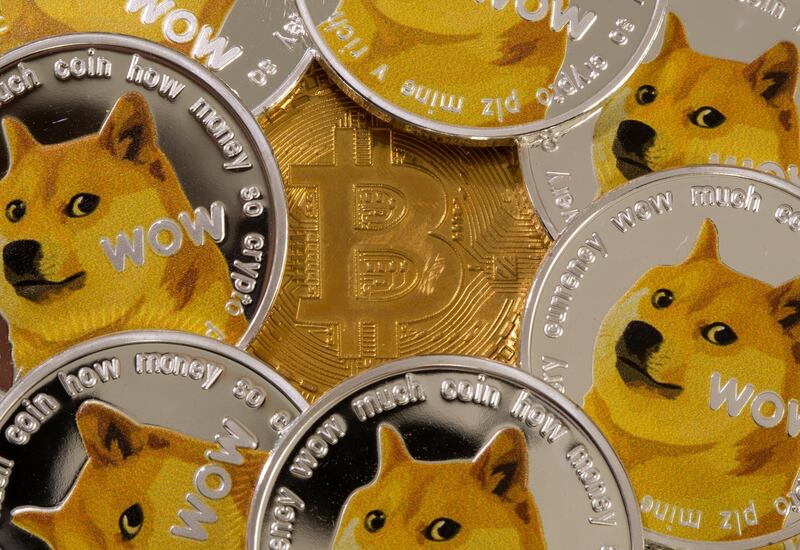 Representations of the virtual currency Dogecoin and Bitcoin are seen in this illustration taken June 16, 2021. REUTERS/Dado Ruvic/Illustration