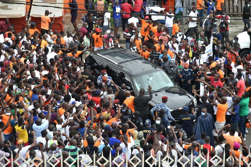 Supporters cheer as they surround the car carrying former Drogba arriving to submit his application to become president of the Ivorian football federation at the FIF headquarter in the Treicheville district of Abidjan. AFP