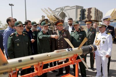 Russia's Defence Minister Sergei Shoigu (C-R) accompanied by Iran's Revolutionary Guards Aerospace Force Commander Amirali Hajizadeh (C-L), examines munitions at the exhibition of the Iranian aerospace industry in Tehran. EPA