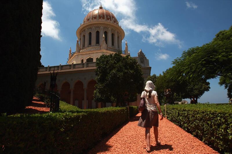 HAIFA, ISRAEL - JULY 14:  A visitor approaches the golden-domed Shrine of the Bab July 14, 2008 in Haifa, Israel. The world spiritual center of the Bahai faith and resting place for the remains of their founder Bab, whose devotees number less than six million worldwide, was declared a World Heritage Site by UNESCO last week.  (Photo by David Silverman/Getty Images)