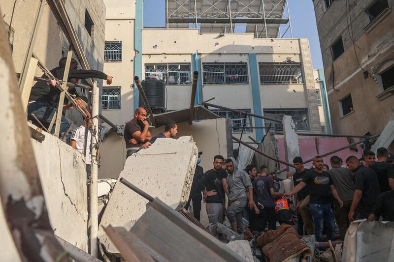 Palestinians search for casualties in the rubble of a house destroyed in an Israeli strike in Rafah. AFP