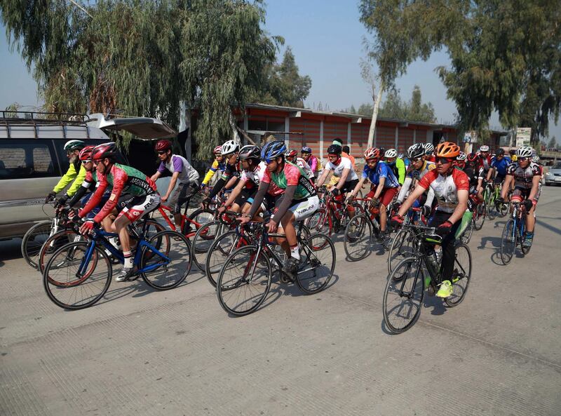 Men cycle during the contest for Peace Cup on the first day of reduction in violence between Afghan Government and Taliban. EPA