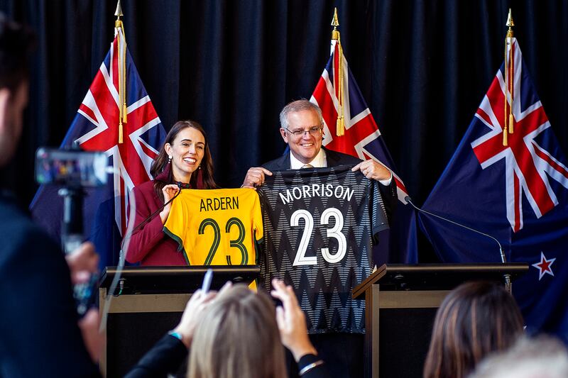 Ms Ardern and Australian Prime Minister Scott Morrison swap football jerseys on May 31, 2021, in Queenstown. Mr Morrison was on a two-day visit to New Zealand, his first overseas visit that year. Getty