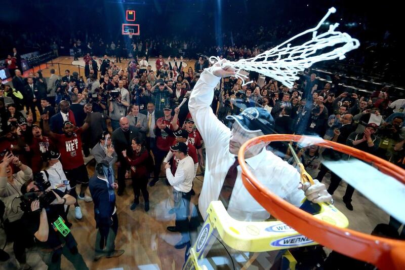 South Carolina Gamecocks head coach Frank Martin cuts down the net after defeating the Florida Gators at Madison Square Garden in New York City. Elsa / Getty Images / AFP
