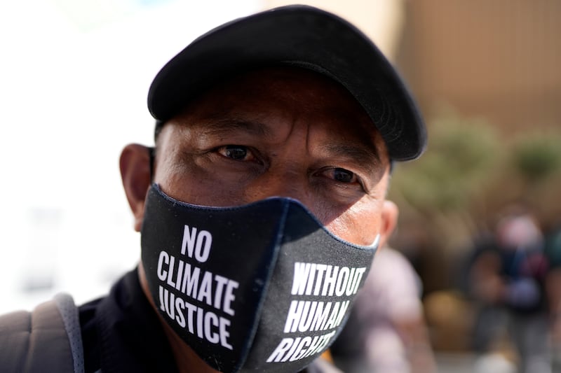 A man wears a face mask that reads "no climate justice without human rights" during a protest at the COP27 UN Climate Summit in Sharm El Sheikh, Egypt. AP
