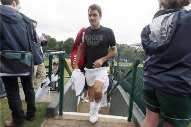Roger Federer of Switzerland, shown here leaving a training session in London on Sunday, won his first title of the year last week and he is hoping to build on that momentum at Wimbledon, which starts Monday. Stefan Wermuth / Reuters