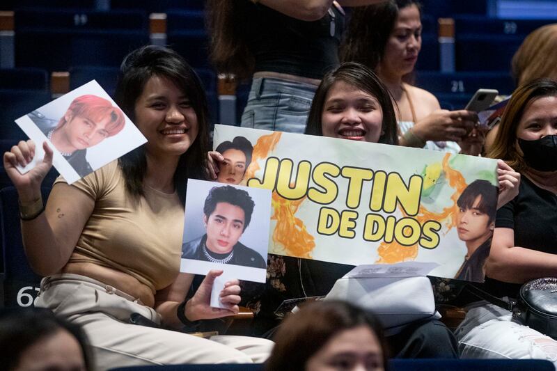 Fans holding up signs at the SB19 concert.