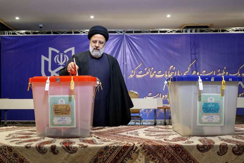 President Ebrahim Raisi casts his vote in Tehran. AP