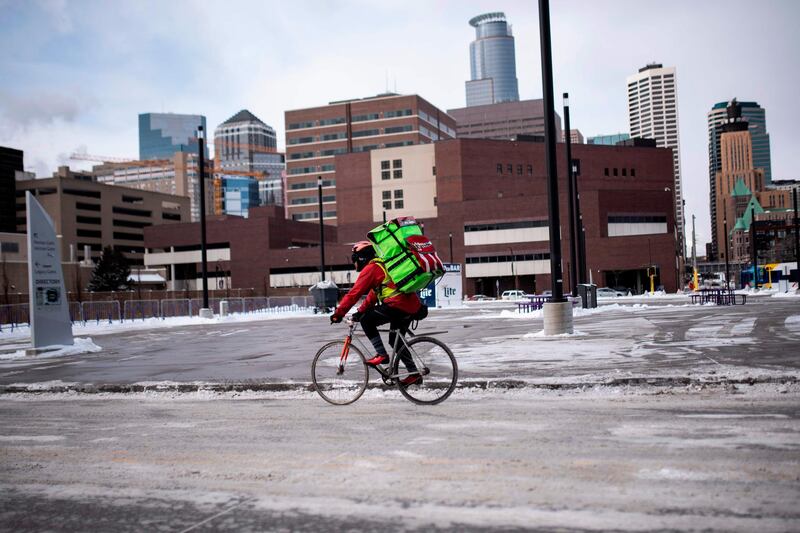 A bicyclist braves the cold while riding through downtown in Minneapolis, Minnesota. AFP