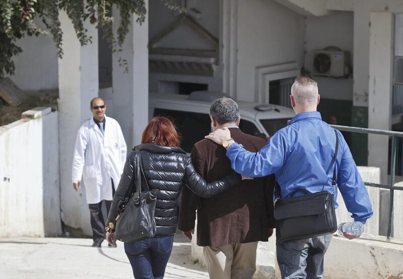 A unidentified relative of a victim of the attack, centre, is escorted by friends at the morgue of the Charles Nicole hospital in Tunis on March 19, 2015. Michel Euler/AP Photo