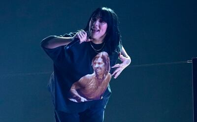 Billie Eilish performs 'Happier Than Ever' with an image of Taylor Hawkins on her T-shirt at the 64th Annual Grammy Awards. AP