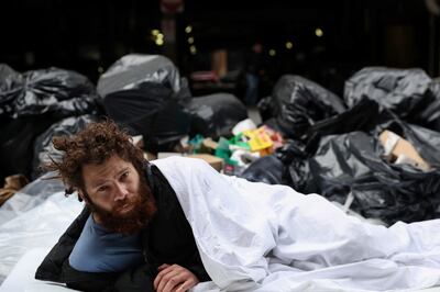 Alex, 27, who said he has been homeless for 8 years, lays on a sidewalk outside Port Authority bus station in the Midtown area of New York City, on May 3. Reuters