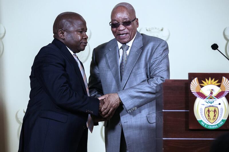 South African president Jacob Zuma, right, shake hands with newly appointed minister of finance David Van Rooyen, left, after a swearing ceremony on December 10, 2015 at the Union Buildings in Pretoria. South Africa’s rand dropped to historic lows on December 10 after president Zuma sacked his respected finance minister in a move that triggered widespread fears about the country’s economic outlook. AFP