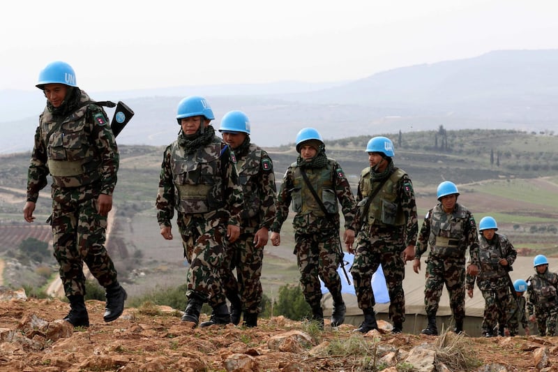 A picture taken from the southern Lebanese village of Meiss al-Jabal on December 16, 2018, shows United Nations Interim Forces in Lebanon (UNIFIL) soldiers patroling on the Lebanese side of the border with Israel.  Israel's army said it has uncovered another Hezbollah "attack tunnel" leading from Lebanon into its territory, the fourth since it started a search-and-destroy operation this month. / AFP / Mahmoud ZAYYAT
