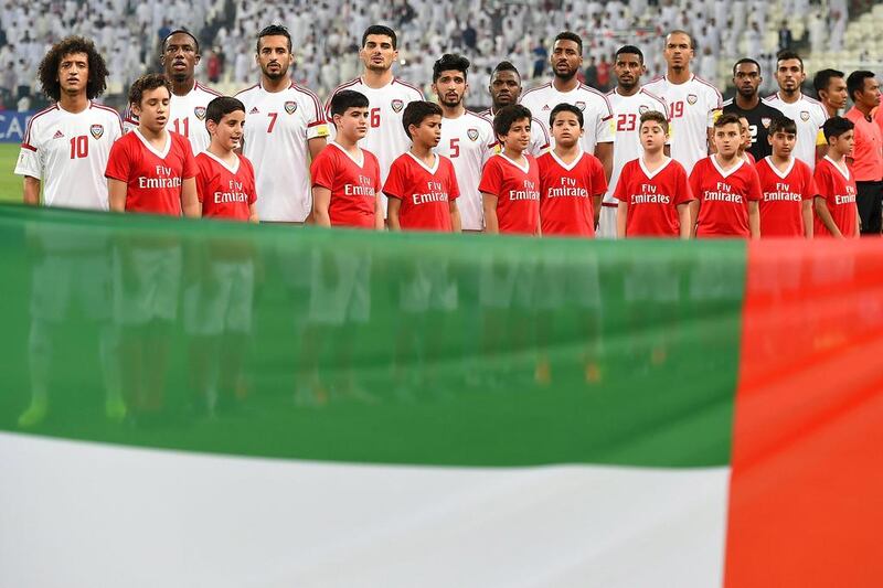 Players of UAE sing the national anthem before the match. Tom Dulat / Getty Images