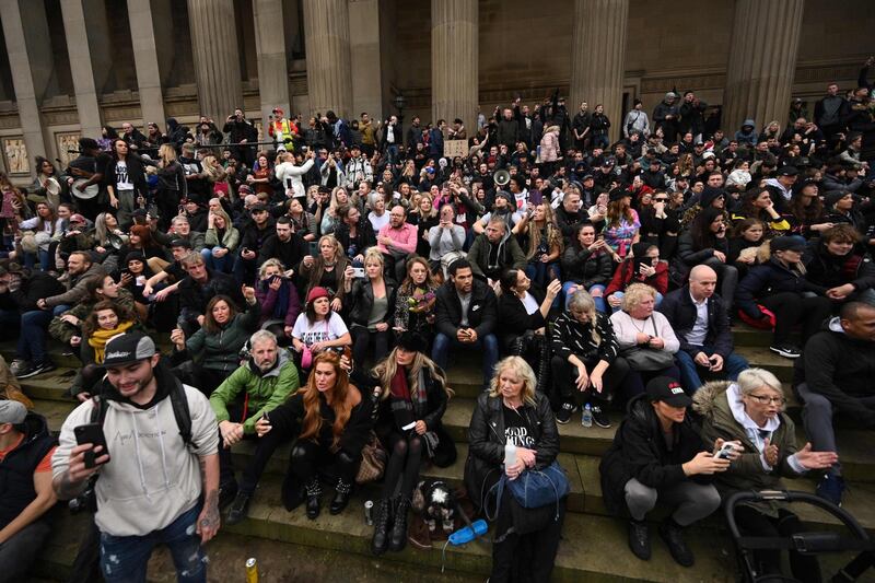 People gather outside St George's Hall during an anti-vax rally protest against vaccination and government restrictions in Liverpool. AFP