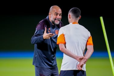 Manchester City's head coach Pep Guardiola, left, talks with Manchester City's Phil Foden during a training session at the King Abdullah Sports City Stadium in Jeddah, Saudi Arabia, Monday, Dec.  18, 2023.  Urawa Reds will play against Manchester City during the semifinal soccer match during the Club World Cup on Tuesday Dec.  19. (AP Photo / Manu Fernandez)