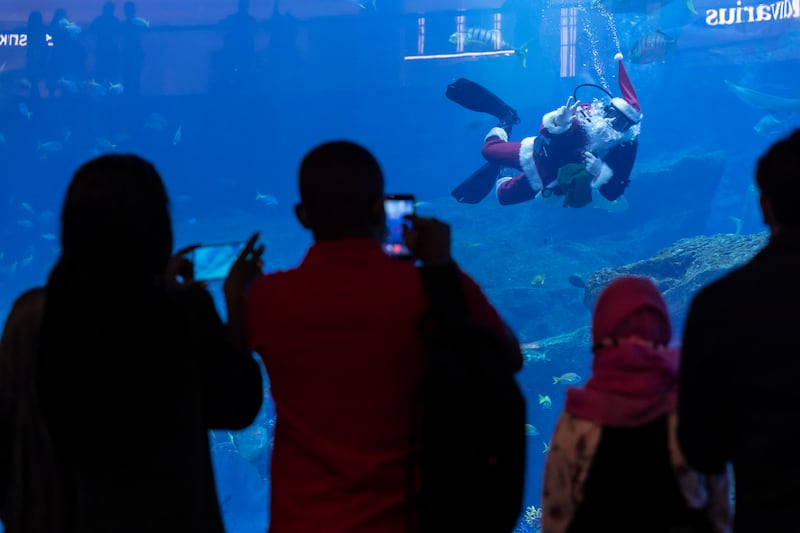 Santa Claus dives in the Dubai Aquarium in Dubai Mall, as part of Christmas celebrations. Antonie Robertson / The National