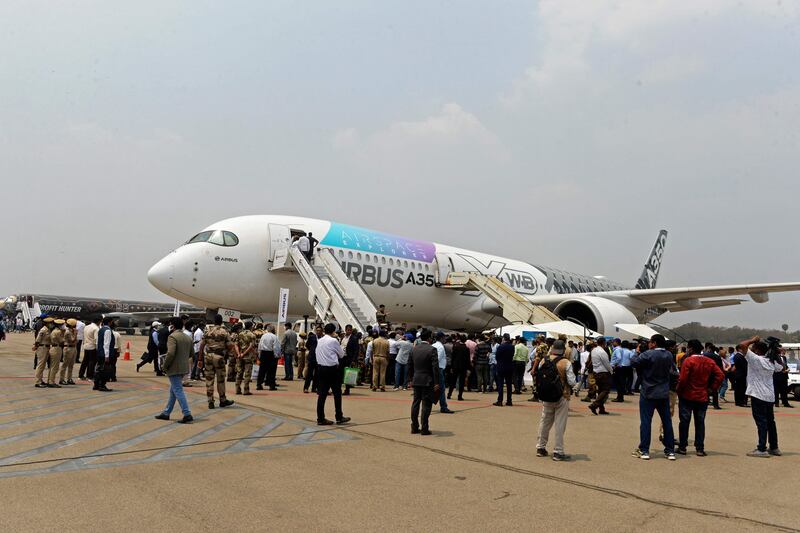 Visitors gather next to an Airbus A350 aircraft on display during Wings India 2022, a civil aviation event organised by the Ministry of Civil Aviation, at Begumpet Airport in Hyderabad. AFP
