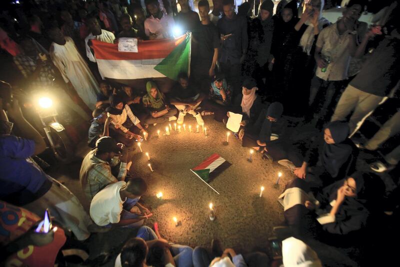 Sudanese protesters take part in a vigil in the capital Khartoum to mourn dozens of demonstrators killed last month in a brutal raid on a Khartoum sit-in, on July 13, 2019. - Crowds of protesters were violently dispersed by men in military fatigues in a pre-dawn raid on a protest site outside army headquarters on June 3. (Photo by ASHRAF SHAZLY / AFP)