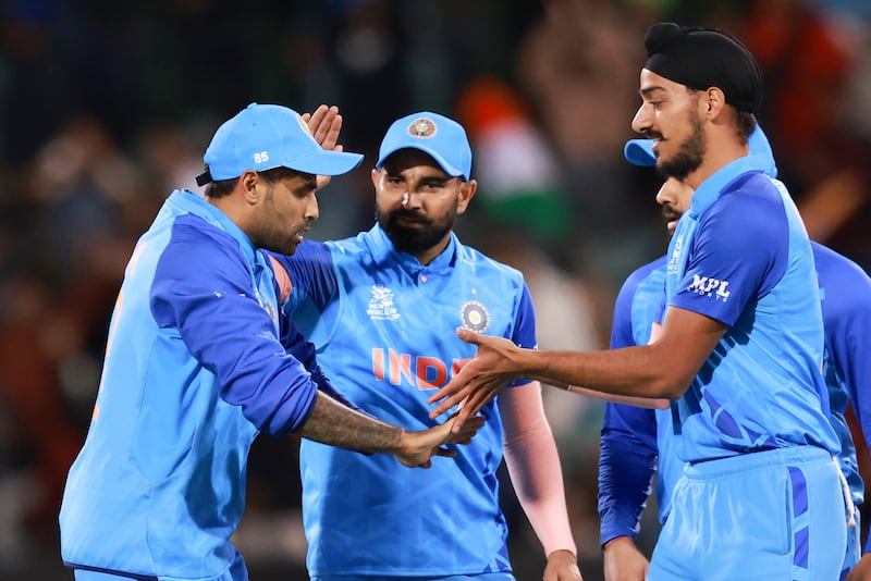 India's Arshdeep Singh, right, congratulates teammate Suryakumar Yadav, left, after taking the wicket of Bangladesh's Afif Hossain. AP