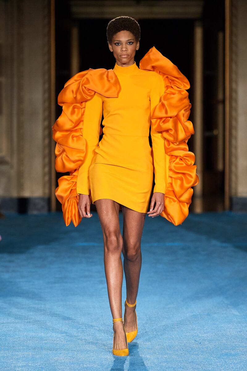 With frilled sleeves, this bright orange mini dress is from Christian Siriano's spring summer 2022 collection. Photo: Christian Siriano