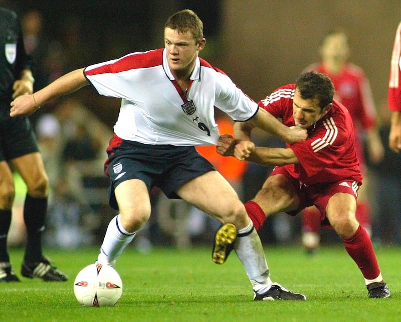England's Wayne Rooney, right, tussles with Buruk Okan of Turkey, during their Euro 2004 championship qualifying game in Sunderland on April 2, 2003. AP