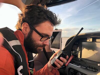 Manos Radisoglou receives information on a radio tranceiver while aboard Moonbird. Hannah Wallace Bowman