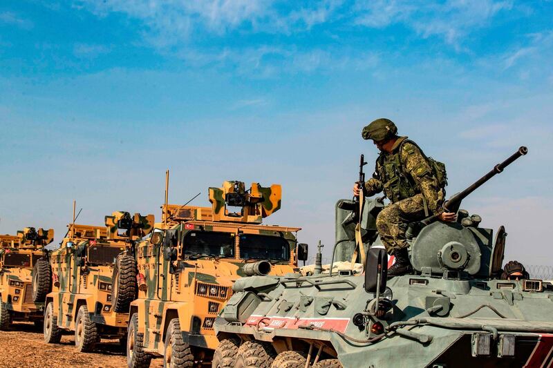 Turkish and Russian military vehicles drive on a joint patrol in the countryside of Darbasiyah town in Syria's northeastern Hasakeh province on the Syrian-Turkish border. AFP