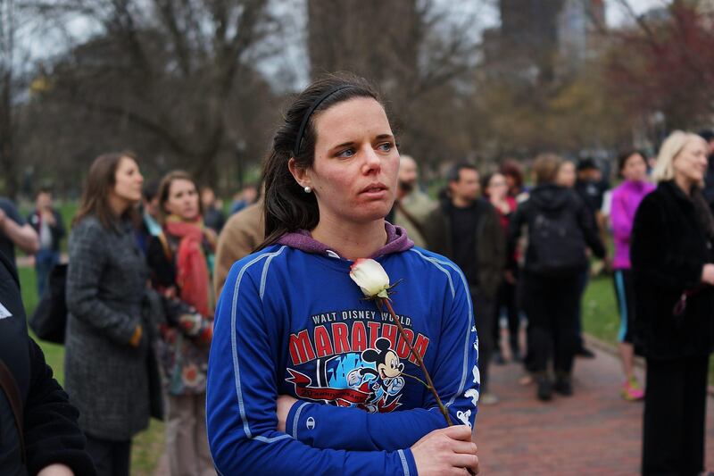 BOSTON, MA - APRIL 16: A woman holds a rose during vigil for victims of the Boston Marathon bombings at Boston Commons on April 16, 2013 in Boston, Massachusetts. The twin bombings, which occurred near the marathon finish line, resulted in the deaths of three people while hospitalizing at least 140. The bombings at the 116-year-old Boston race, resulted in heightened security across the nation with cancellations of many professional sporting events as authorities search for a motive to the violence.   Spencer Platt/Getty Images/AFP== FOR NEWSPAPERS, INTERNET, TELCOS & TELEVISION USE ONLY ==
 *** Local Caption ***  925923-01-09.jpg