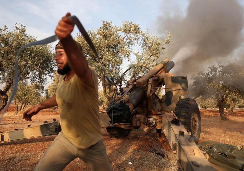 Members of Syria's opposition National Liberation Front load a 155mm gun before firing toward positions of Russian and regime forces in retaliation to a Russian air strike on a training camp two days before. AFP