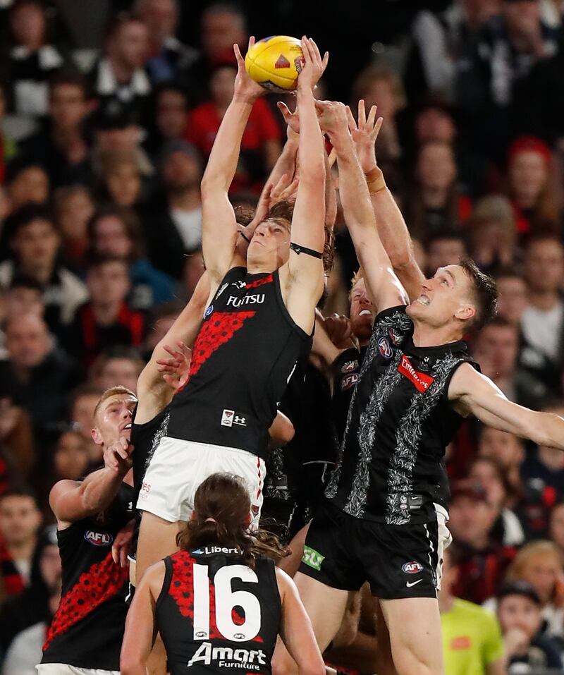 Harrison Jones of the Bombers marks the ball against Jack Madgen of the Magpies. Getty