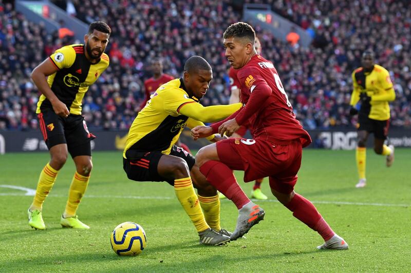 Liverpool's Brazilian forward Roberto Firmino takes on Watford's Christian Kabasele. AFP