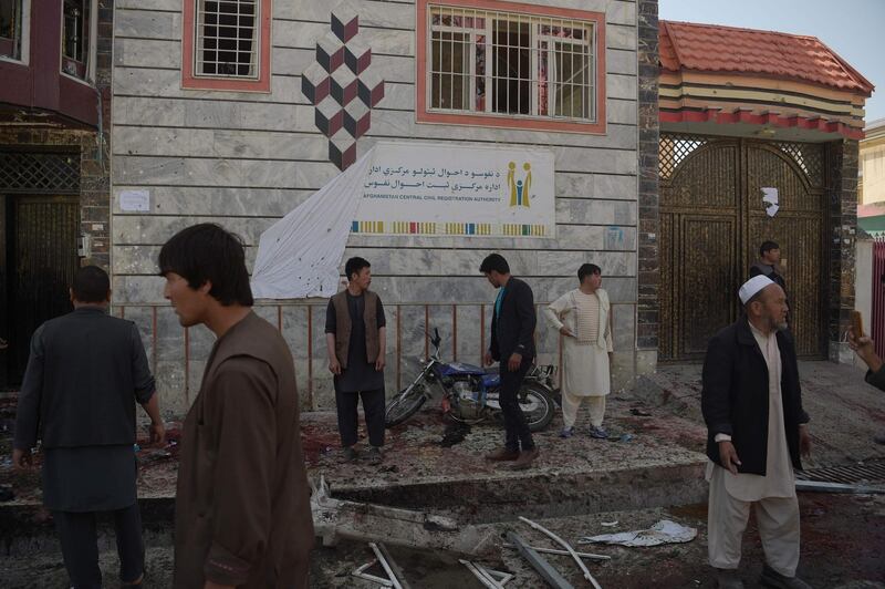 Afghan residents inspect the site of a suicide bombing outside a voter registration centre in Kabul on April 22, 2018. Shah Marai / AFP