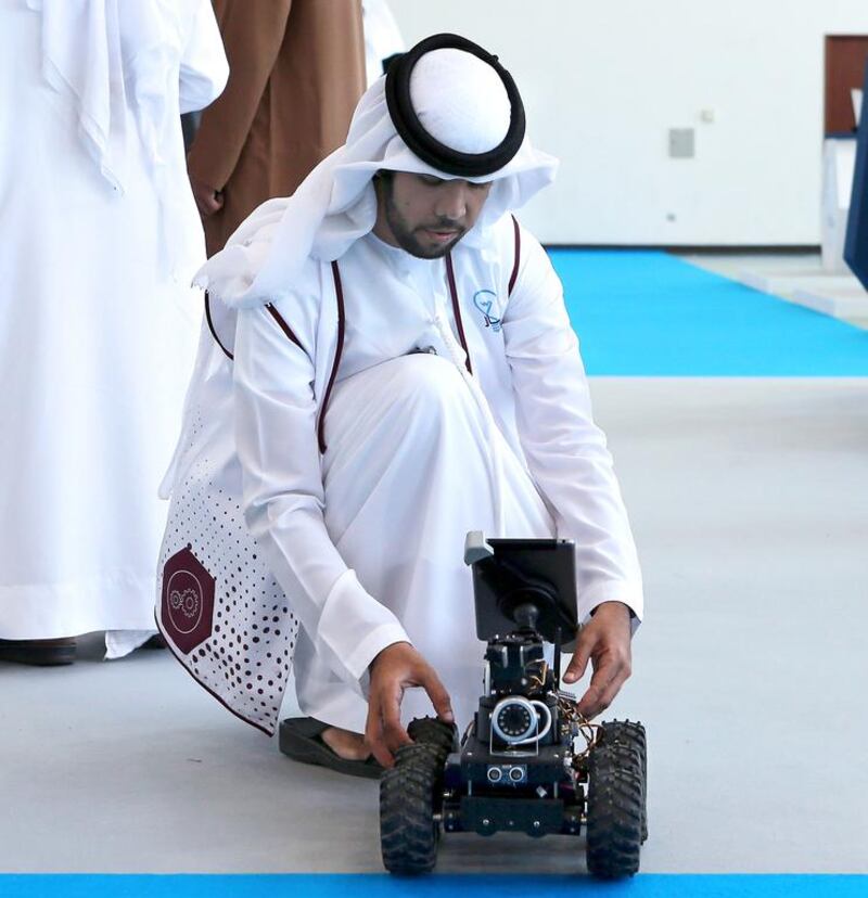 Saeed Al Yammahi checks on his design of a tele-operated mobile robot <a href="http://www.thenational.ae/business/the-life/abu-dhabis-petroleum-institute-shows-talent-beyond-energy">at the Ebtikar Innovation contest</a> at the Petroleum Institute in April. Ravindranath K / The National