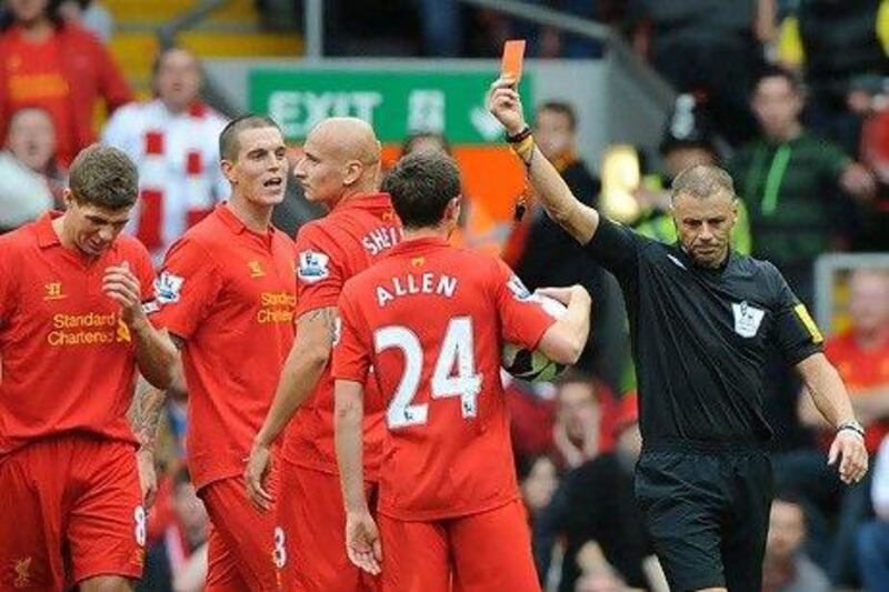 Jonjo Shelvey, centre, is sent off for his challenge on Jonny Evans at Anfield yesterday. Peter Powell / EPA