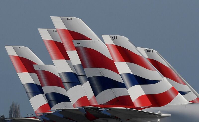 FILE PHOTO: Tail Fins of British Airways planes are seen parked at Heathrow airport, in Britain, March 31, 2020. REUTERS/Toby Melville/File Photo