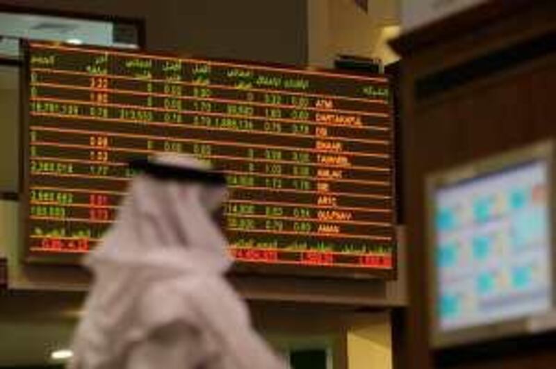 An Emirati man walks past the stock market activity board at the stock exchange in Dubai on December 10, 2009. Dubai's stock market closed 7.0 percent higher, its biggest gain since the debt crisis exploded, and led by Emaar Properties after it called off a merger with state-owned entities.<br />AFP PHOTO/STR *** Local Caption ***  420032-01-08.jpg