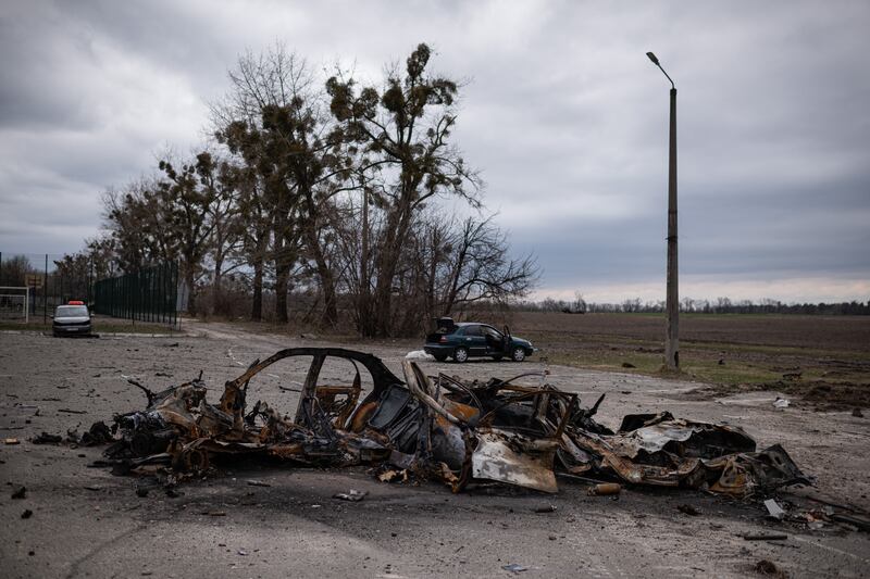 Burnt cars are seen next to a field in Hostomel, Ukraine. Getty Images