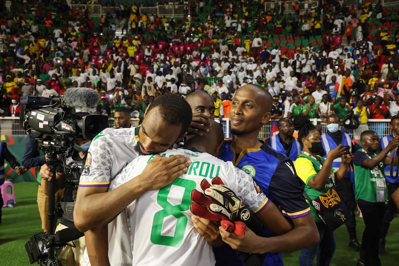 Comoros midfielder Fouad Bachirou is consoled by teammates after defeat to Cameroon. AFP