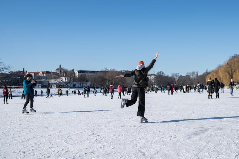 People skate and walk on frozen Landwehr Canal in the Kreuzberg district during the second wave of the coronavirus pandemic in Berlin, Germany. Getty