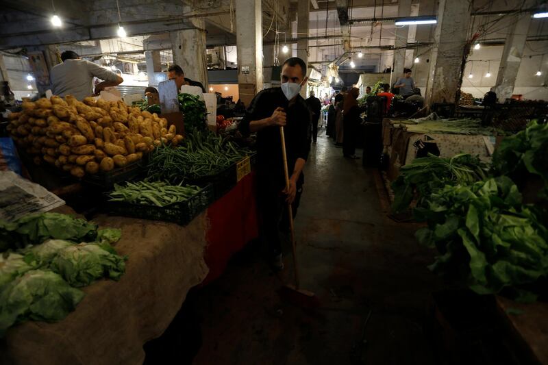 A man sweeps an alley of a food market in Algiers, Tuesday April 21, 2020. Algerians are shopping to prepare the month of Ramadan which starts on Thursday in Algeria. AP Photo