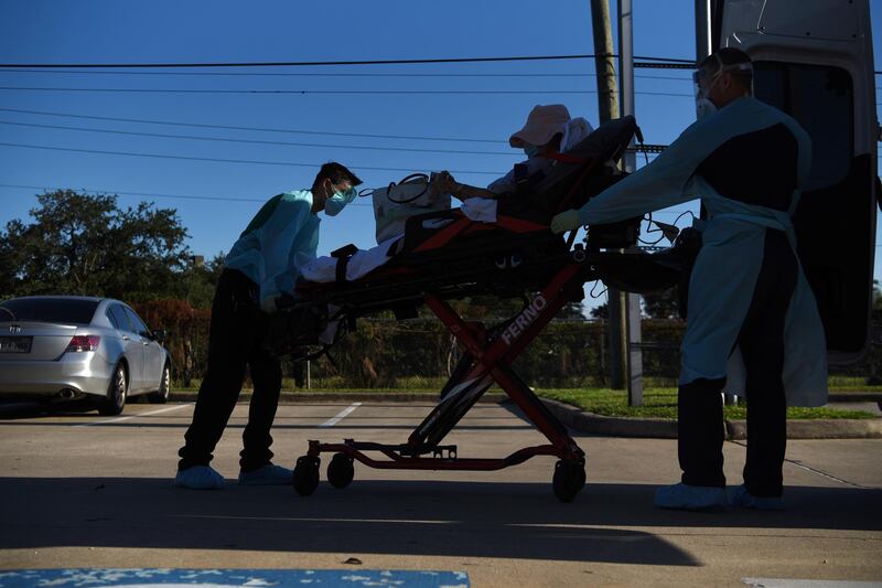 Orion EMS employees wheel a patient who tested positive for Covid-19 into an ambulance in Houston, Texas, USA. Reuters