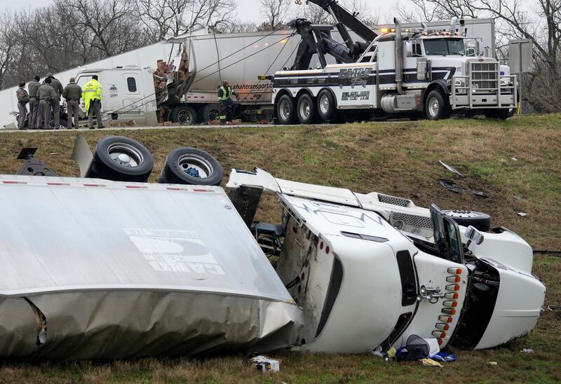 Officials investigate an accident involving big rig lorries on a motorway in Austin, Texas. Austin American-Statesman / AP