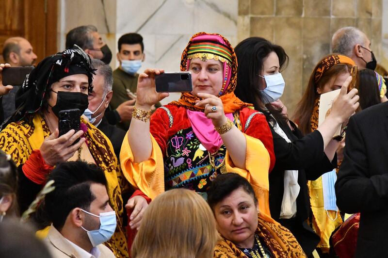 People wait for Pope Francis before his arrival inside the Syriac Catholic Church of the Immaculate Conception, in the predominantly Christian town of Qaraqosh (Baghdeda). AFP